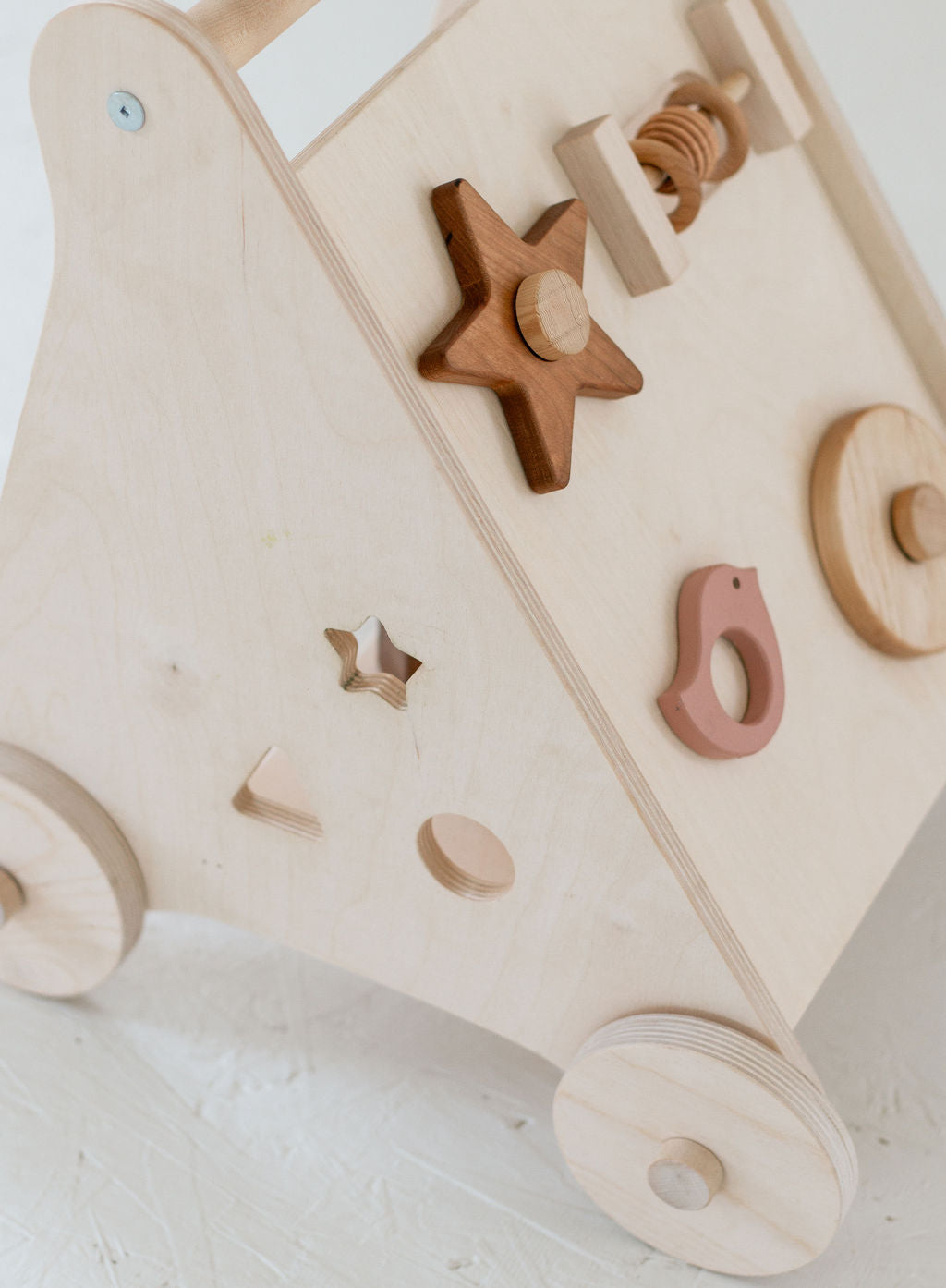 Wooden toy with various shapes on a light background