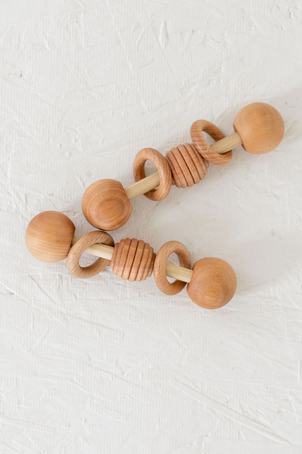 Wooden baby teething ring on a white background