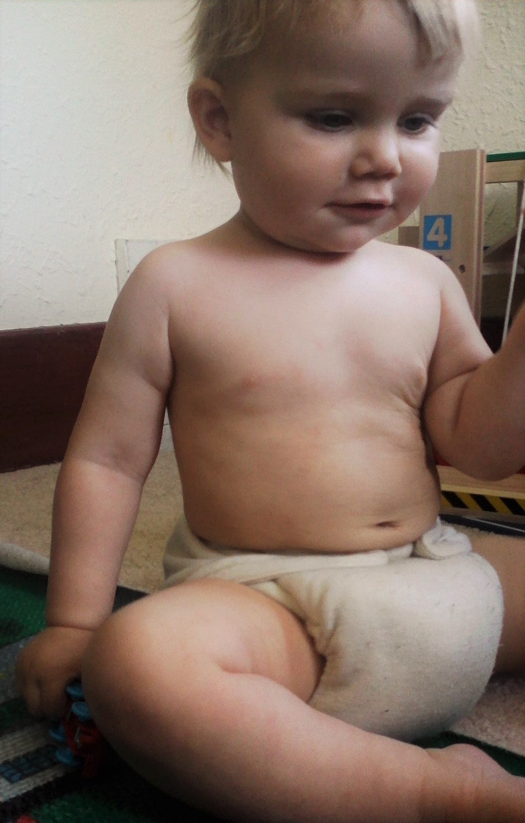 Young child wearing a diaper in an indoor setting