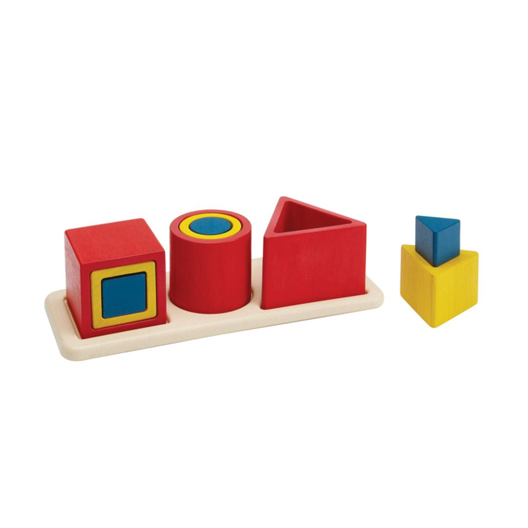 Colorful geometric shape sorting toy on a white background