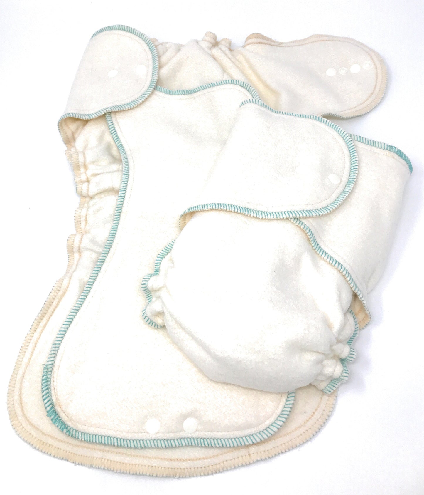 Set of white cloth diapers with blue stitching on a white background