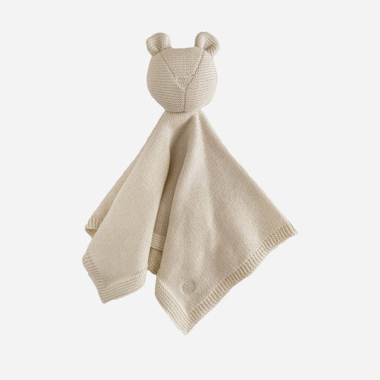 Beige knitted baby comfort blanket with bear ears and a face on a white background