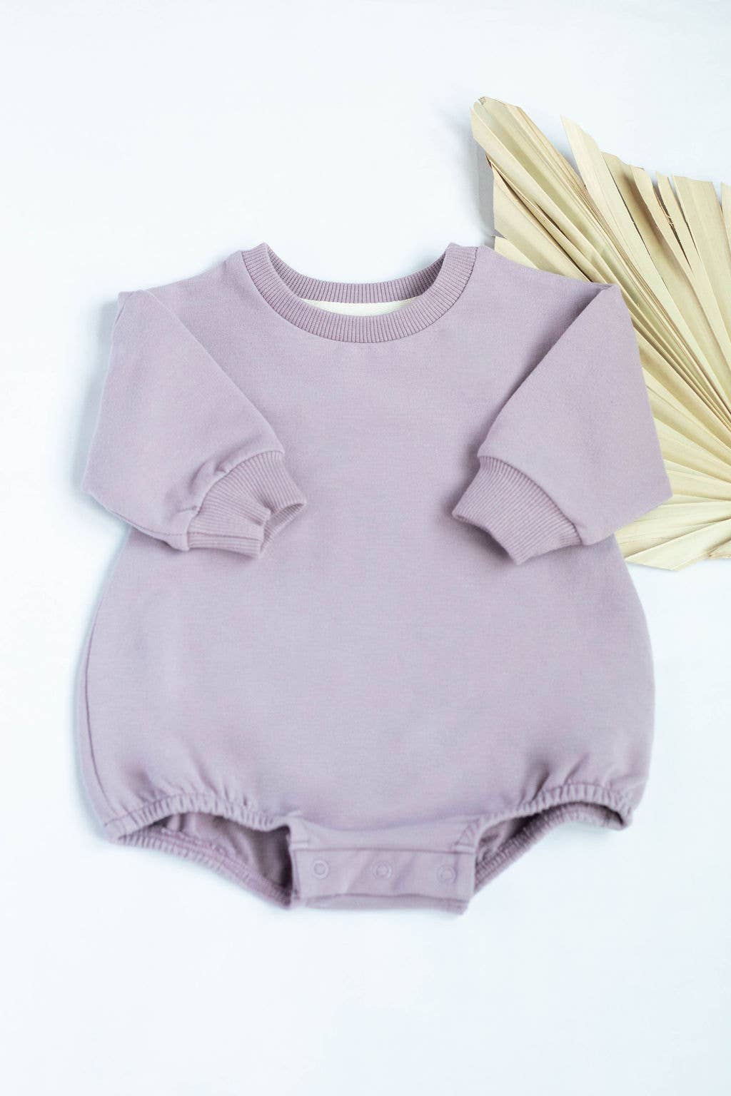 Purple baby romper with long sleeves on a white background