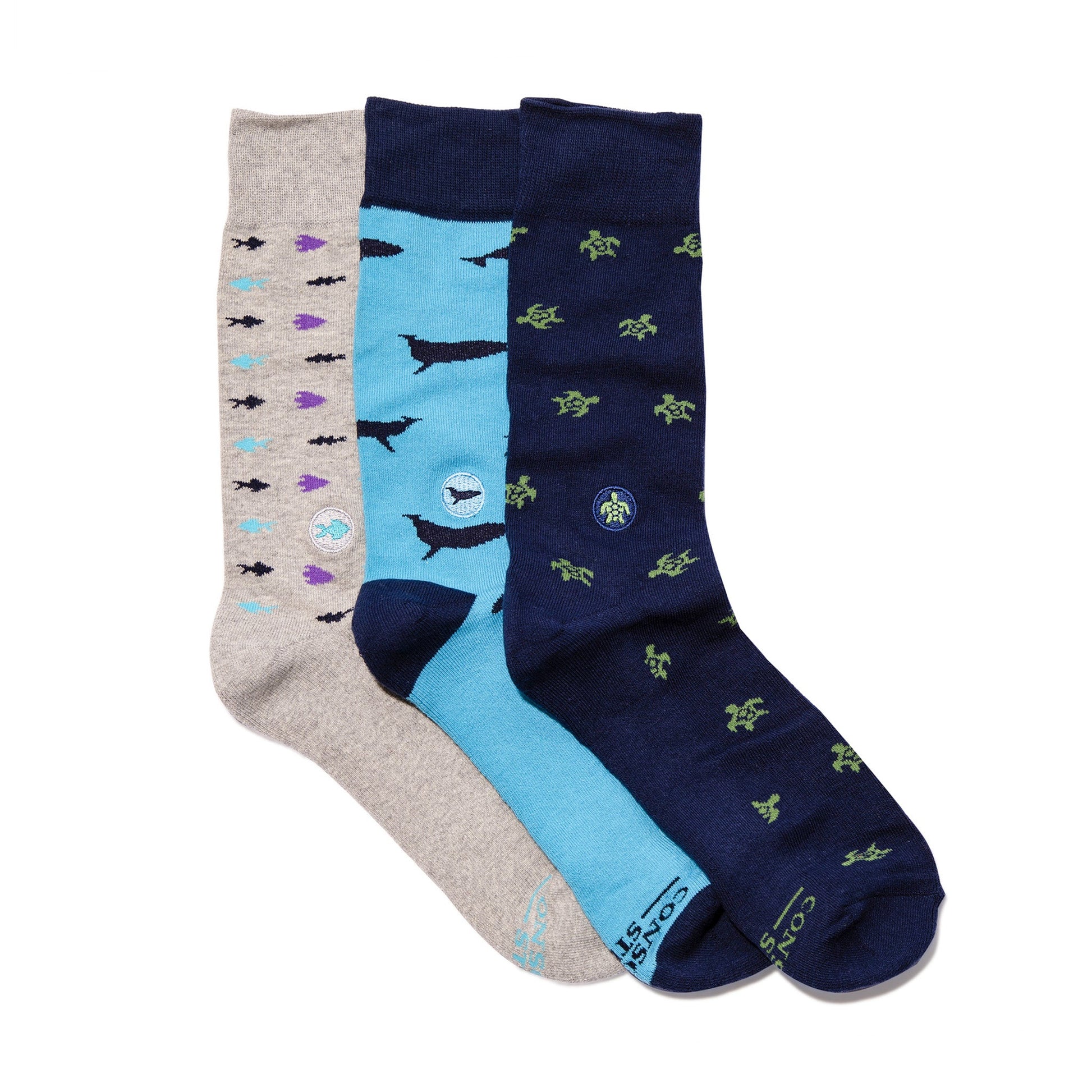Three pairs of socks in gray, blue, and navy with various patterns on a white background.