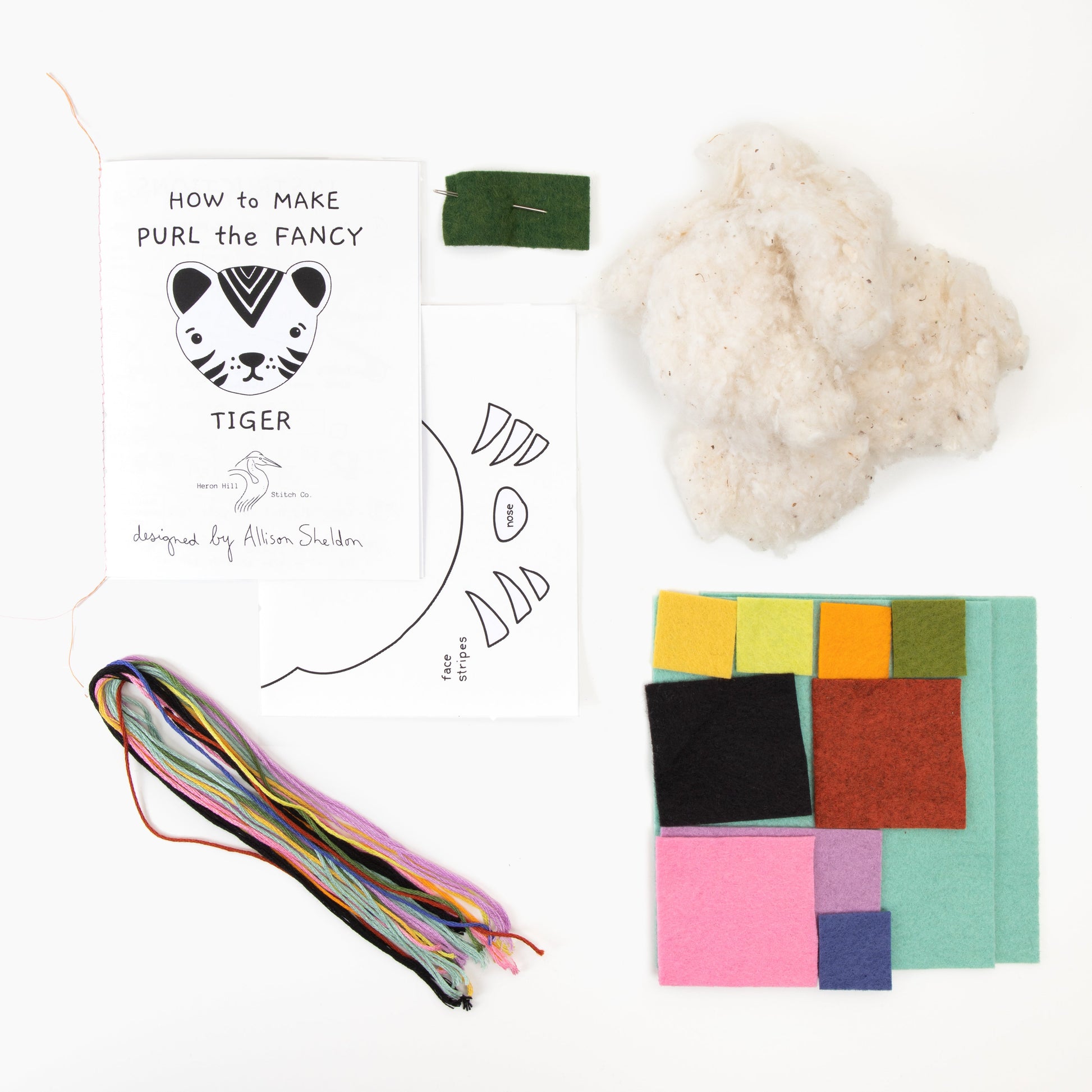 Crafting kit with yarn, felt squares, and instructions on a white background