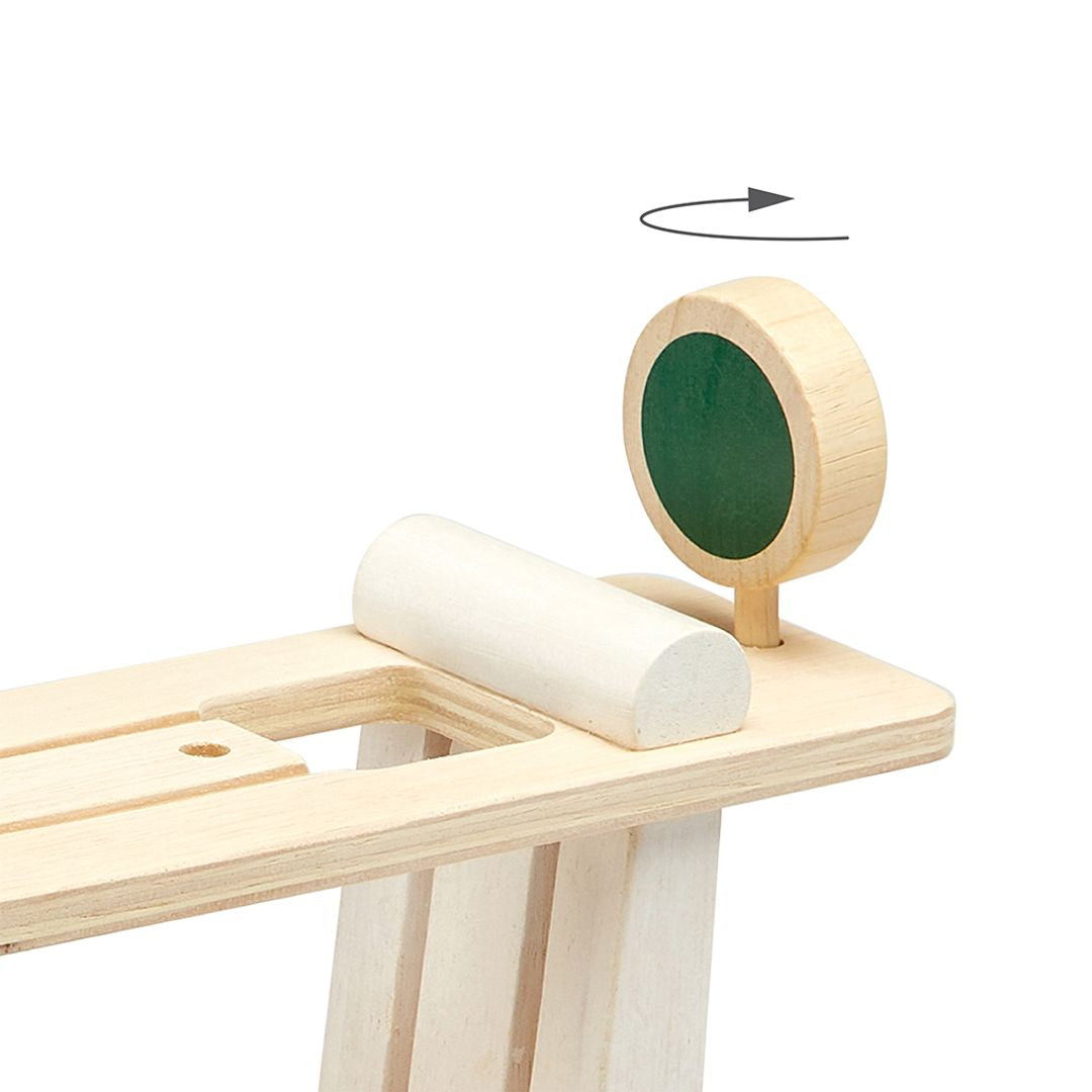 Wooden toy with cylindrical components on a white background