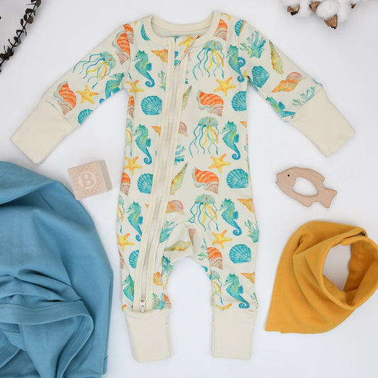Baby onesie with sea creature pattern on a white background
