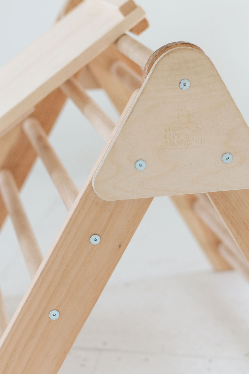 Wooden climbing toy with a white background
