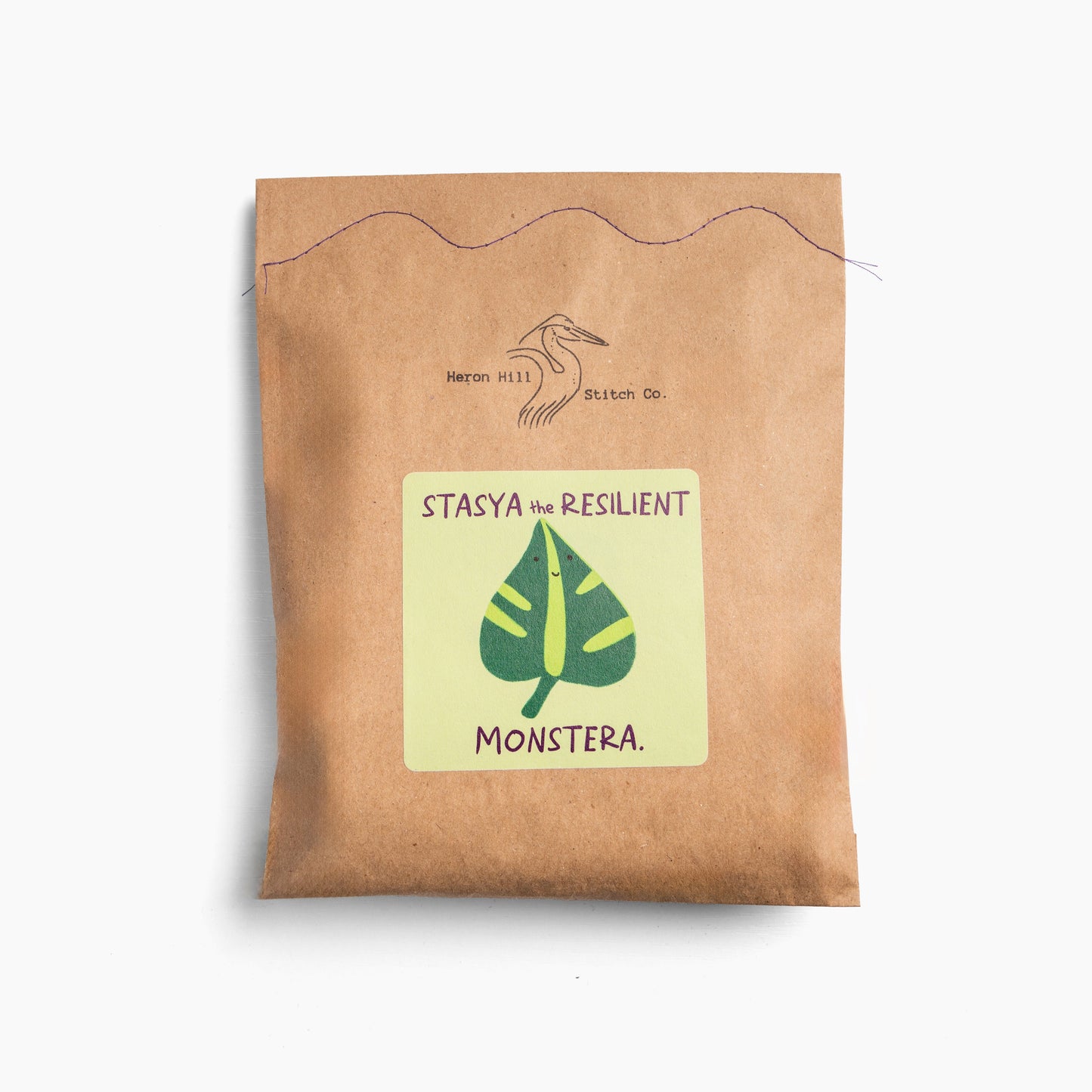 Kraft paper package with a label featuring a green leaf illustration and text on a white background