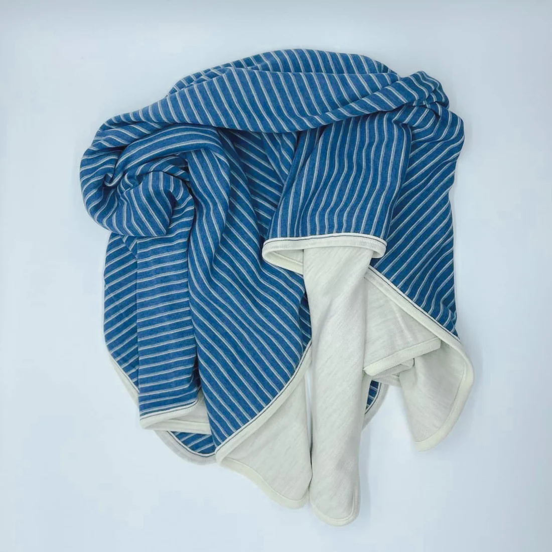 Blue and white striped blanket on a white background