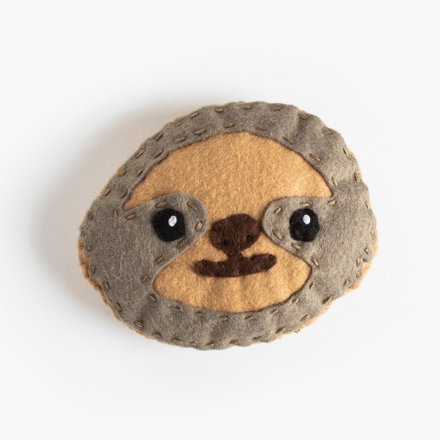 Stuffed toy sloth head on a white background