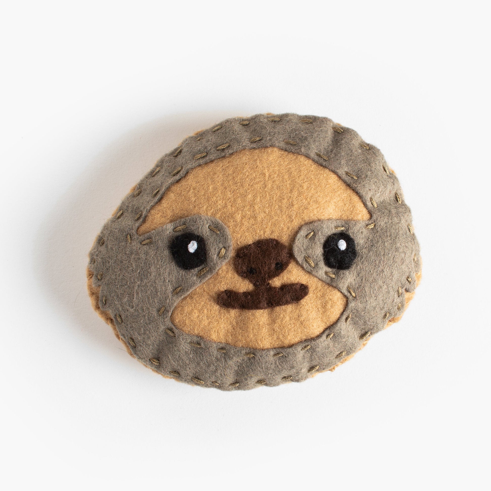 Stuffed toy sloth head on a white background