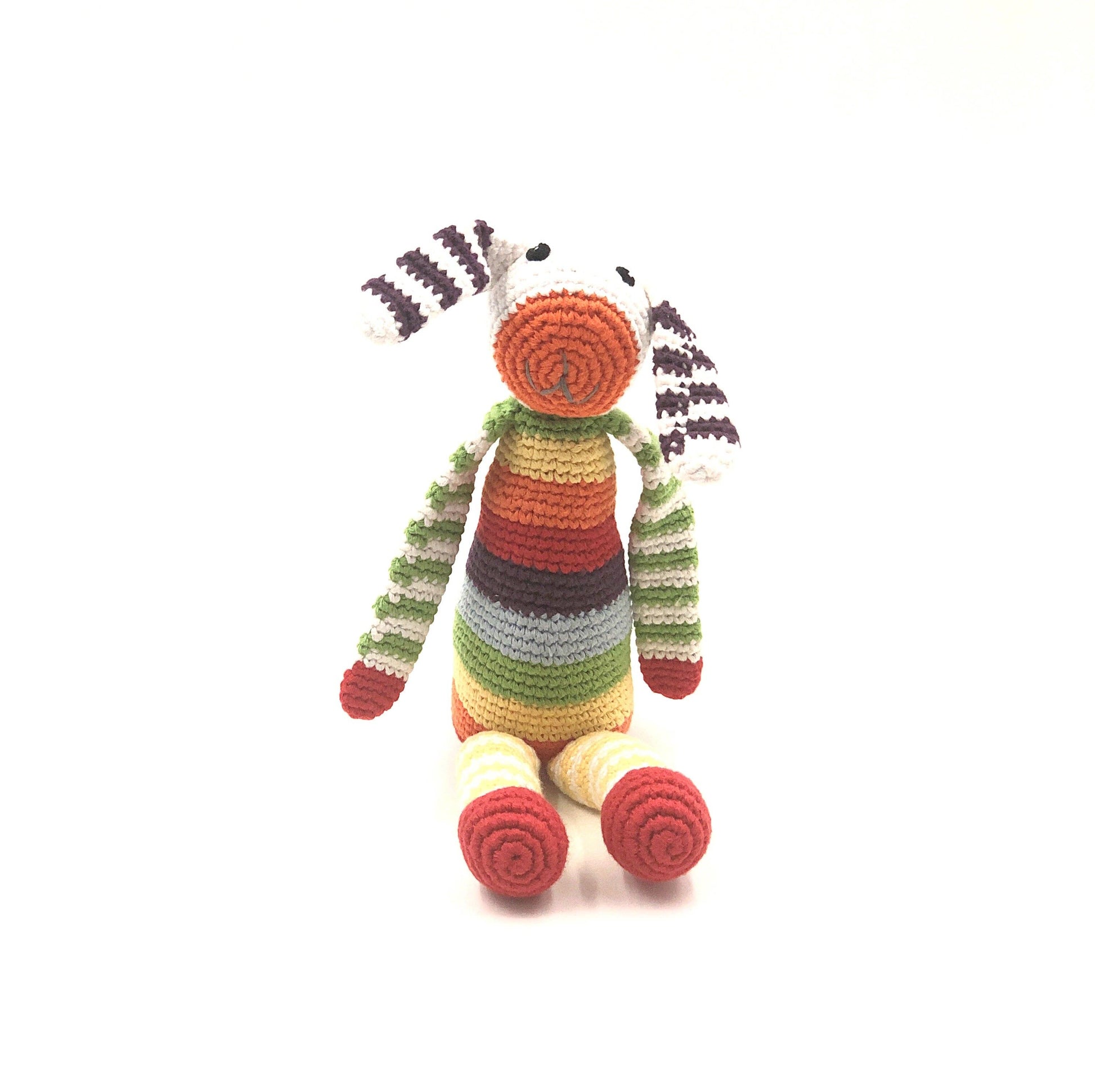 Colorful striped toy zebra on a white background
