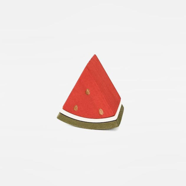 a wooden triangle piece of watermelon on a white back ground