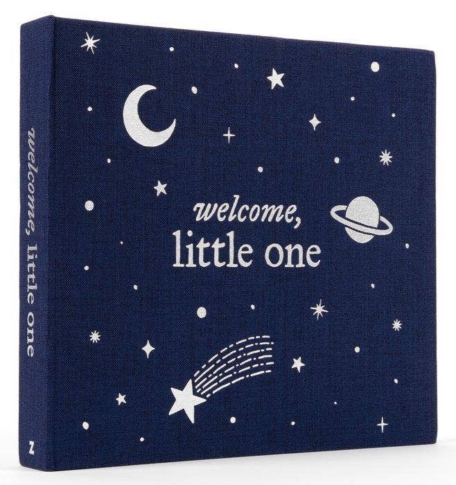Navy blue album with white celestial designs and 'welcome, little one' text on a white background