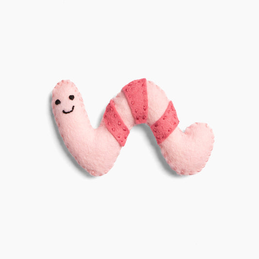 Pink plush toy shaped like a worm on a white background