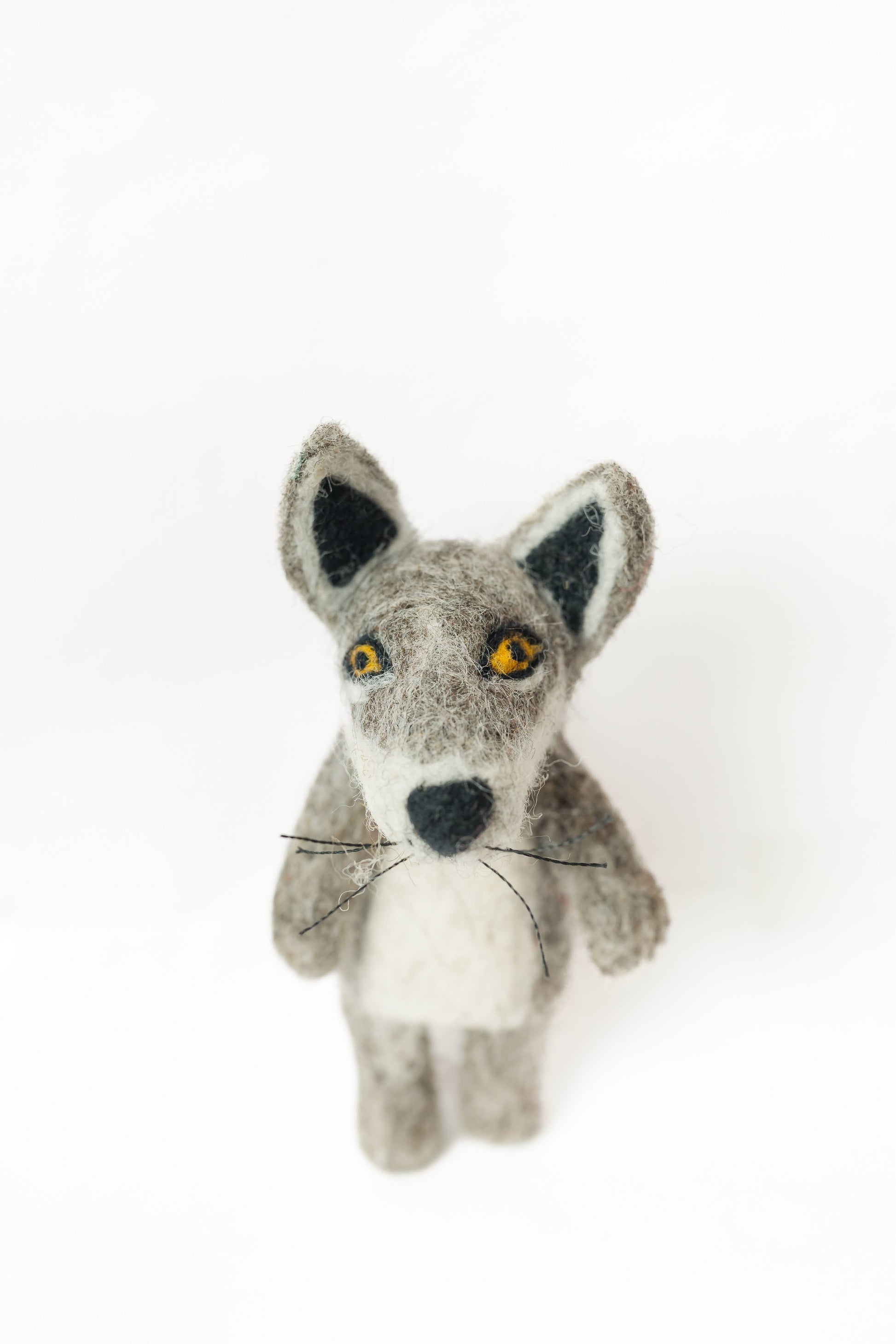 Stuffed toy wolf with black and white details on a white background