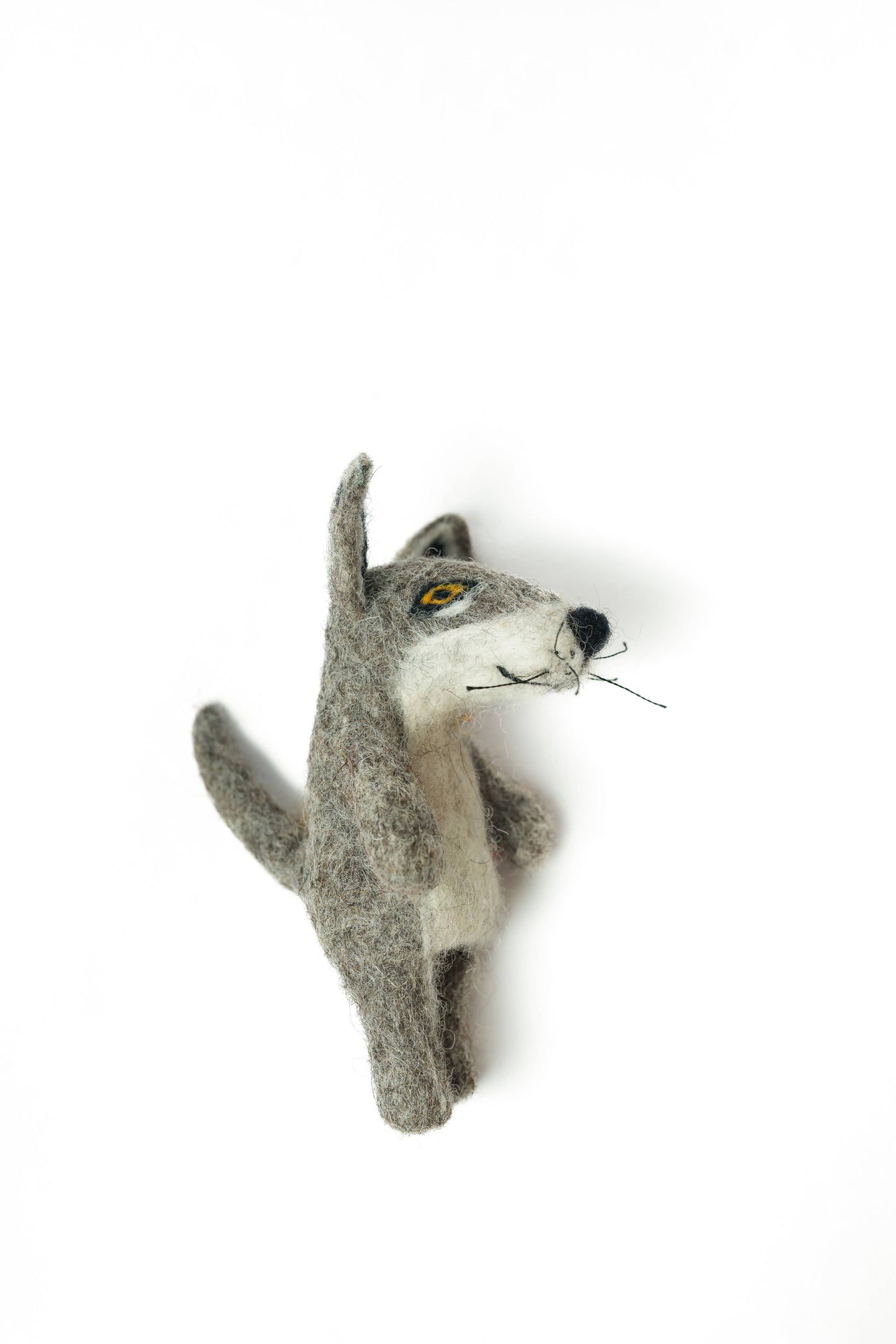 Felted wolf head decoration on a white background