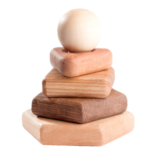 Stack of wooden blocks with a sphere on top against a white background