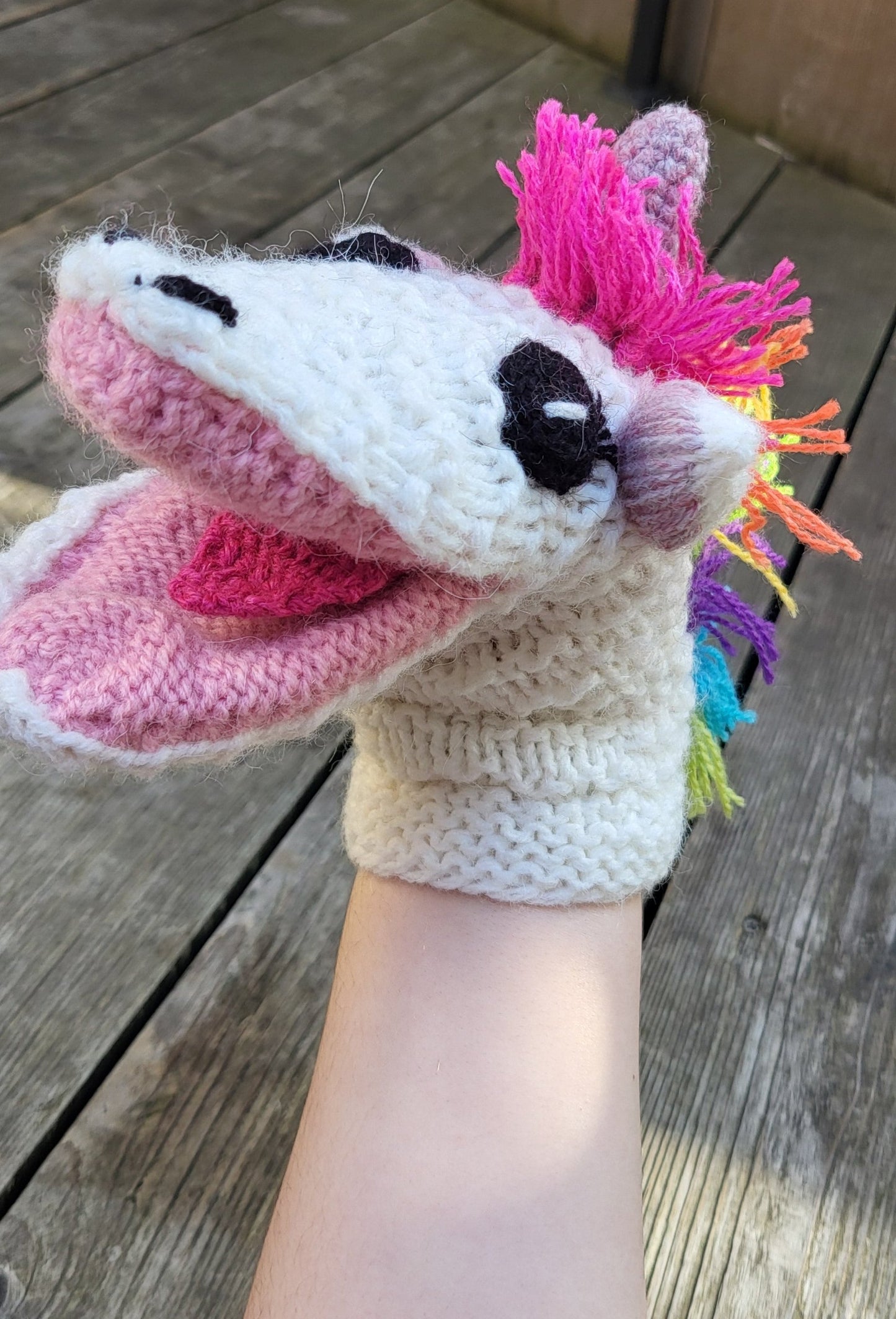 unicorn wool hand puppet on a hand