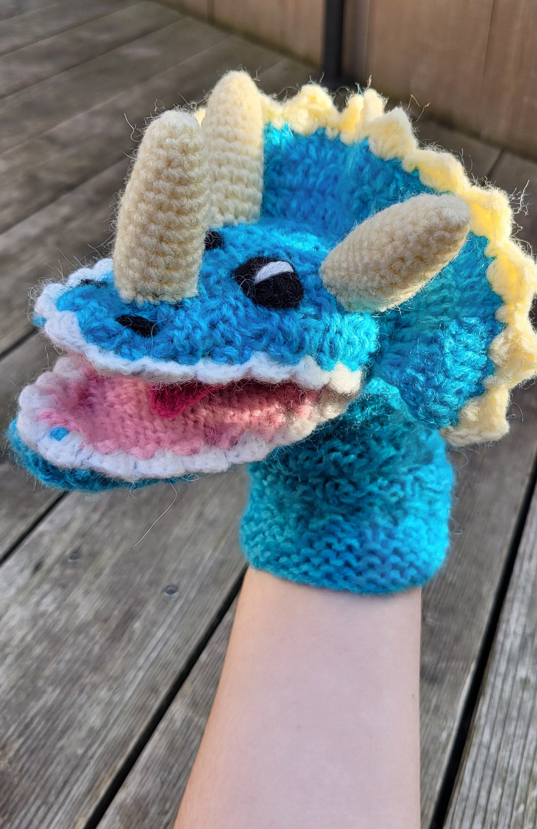 triceratops wool hand puppet on a hand