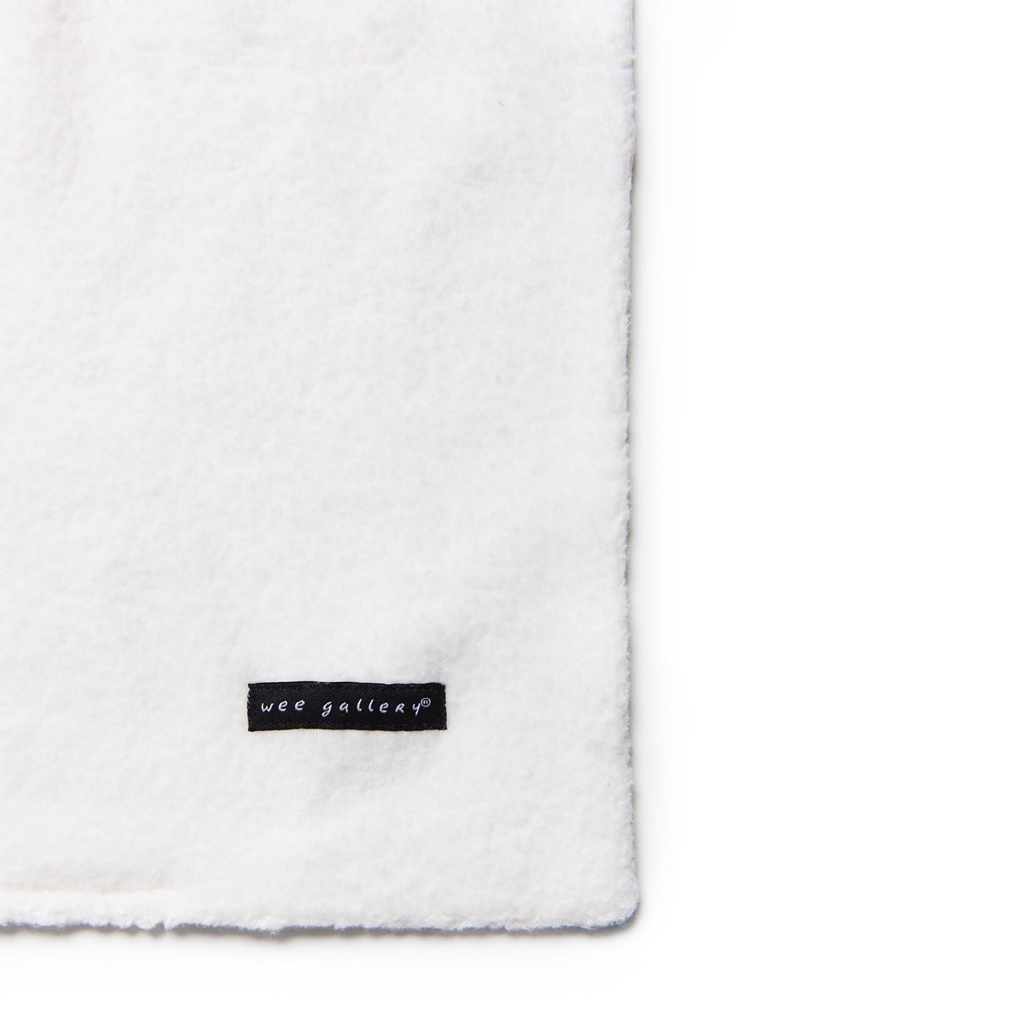 White blanket with a 'wee gallery' label on a white background