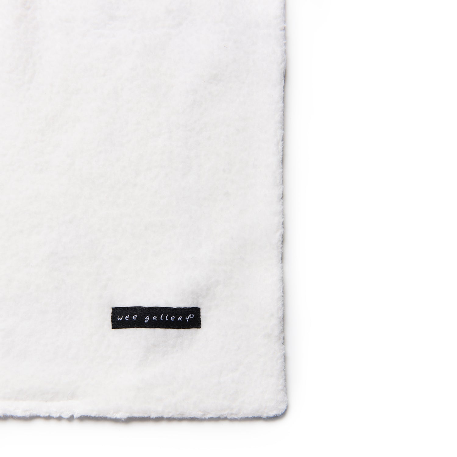 White blanket with a 'wee gallery' label on a white background