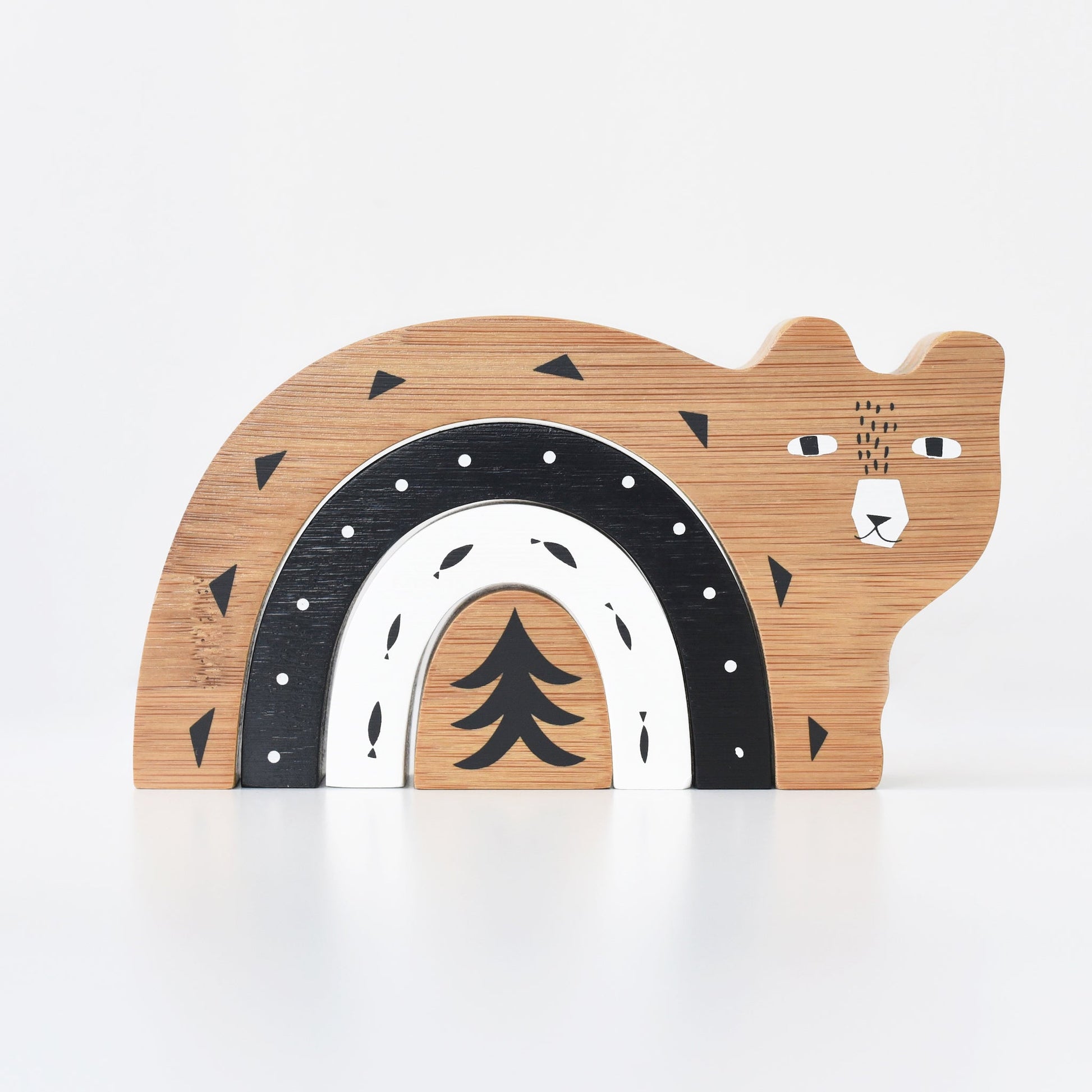 Wooden bear-shaped toy with black, white, and brown design on a white background