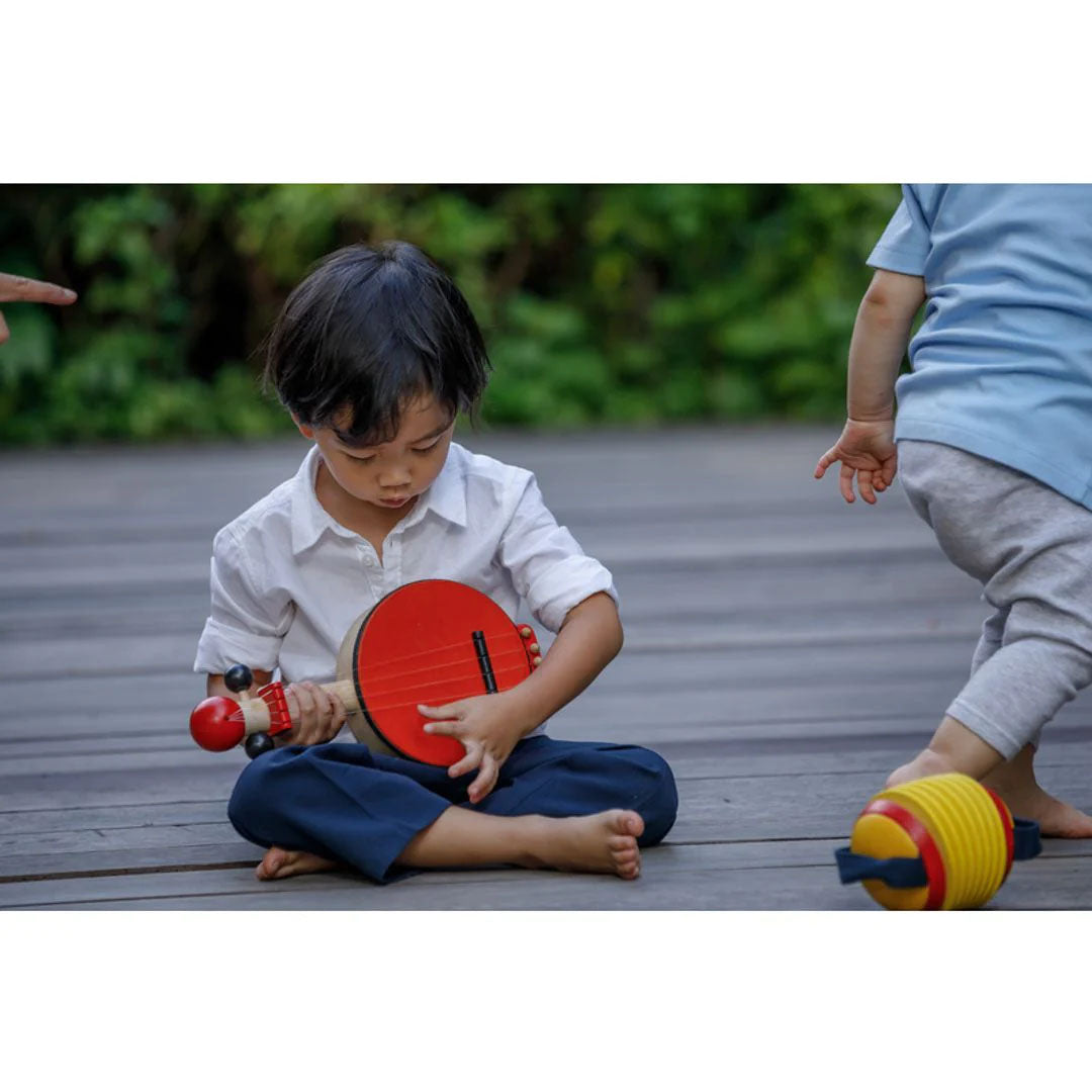 Child Playing a Banjo by Plan Toys