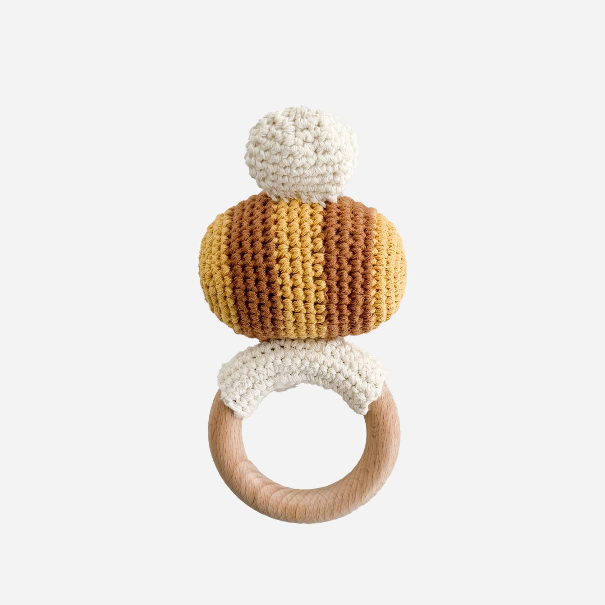 Crocheted bee teether with wooden ring on a white background