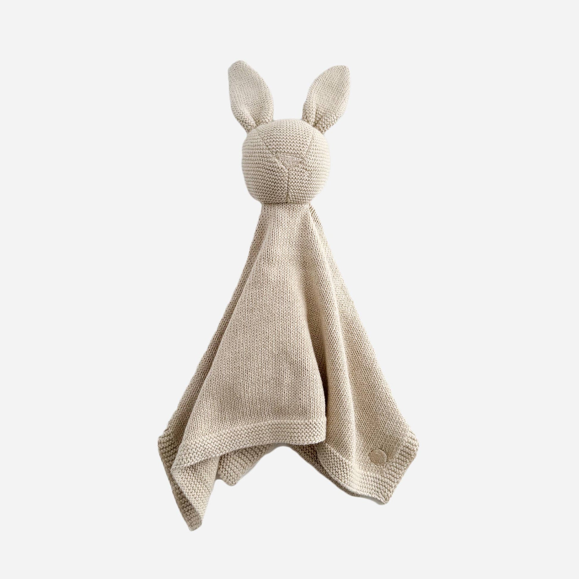 Knitted bunny comfort blanket on a white background