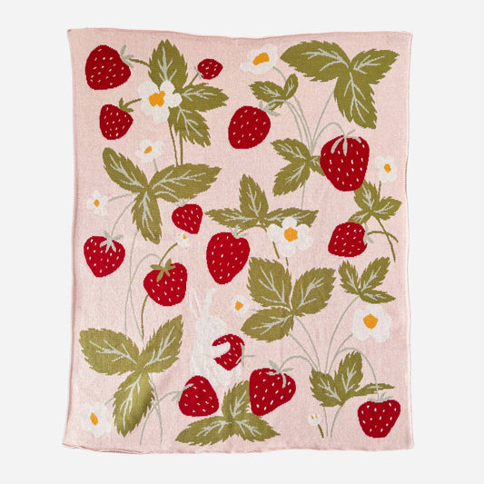 Blanket with strawberry pattern on a pink background