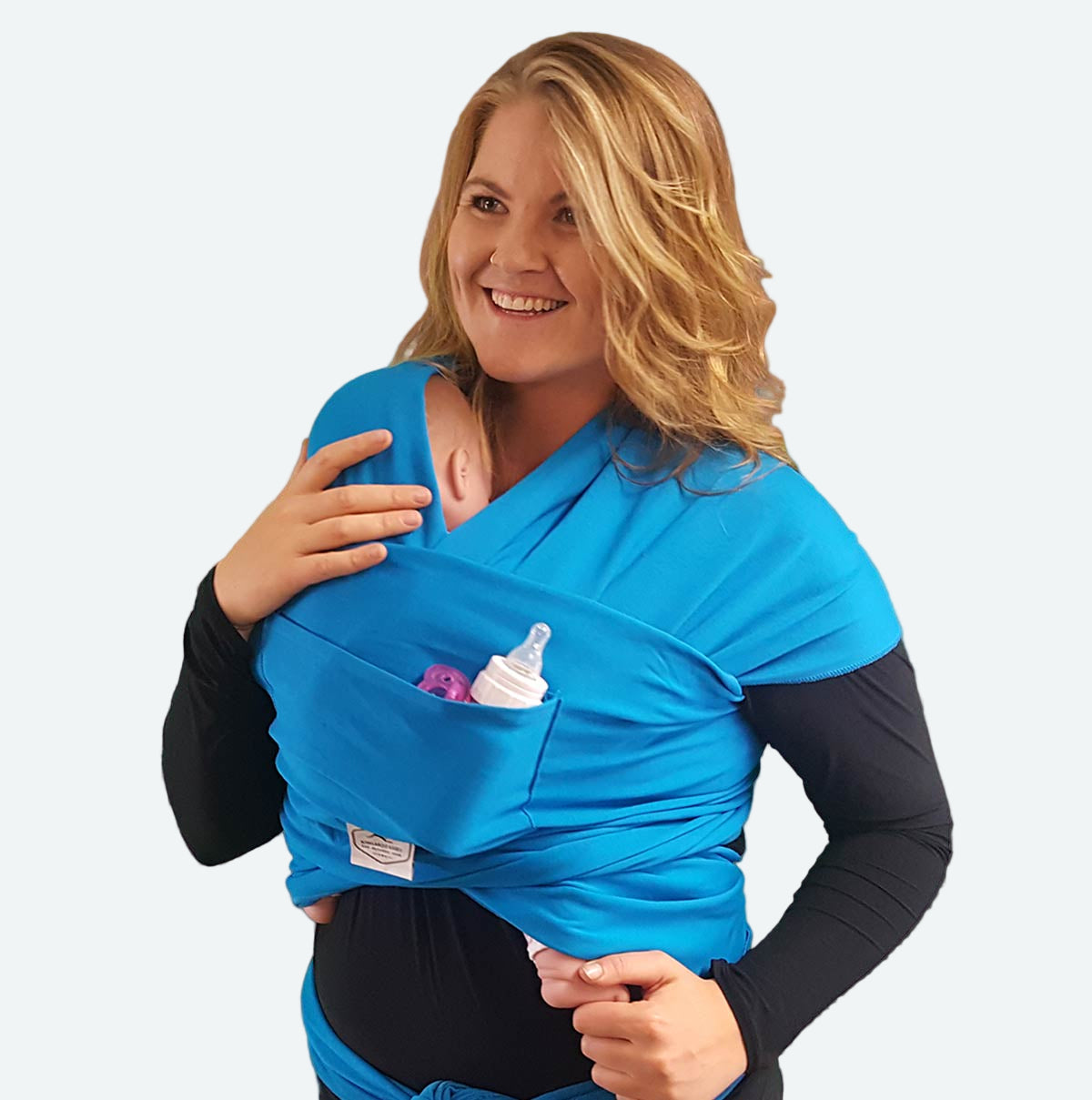 Woman wearing a blue baby wrap carrier against a light purple background