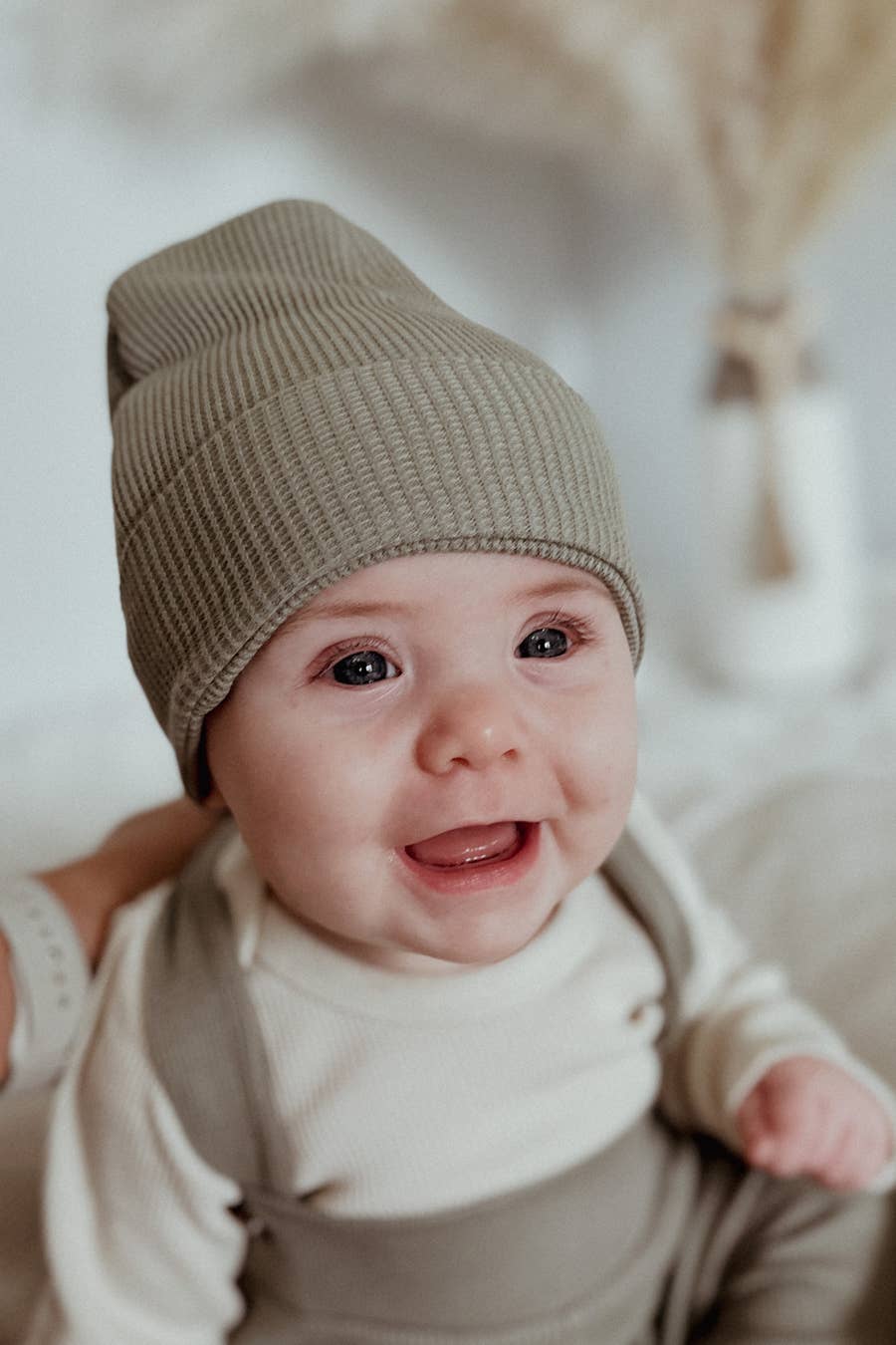 baby wearing organic olive waffle beanie