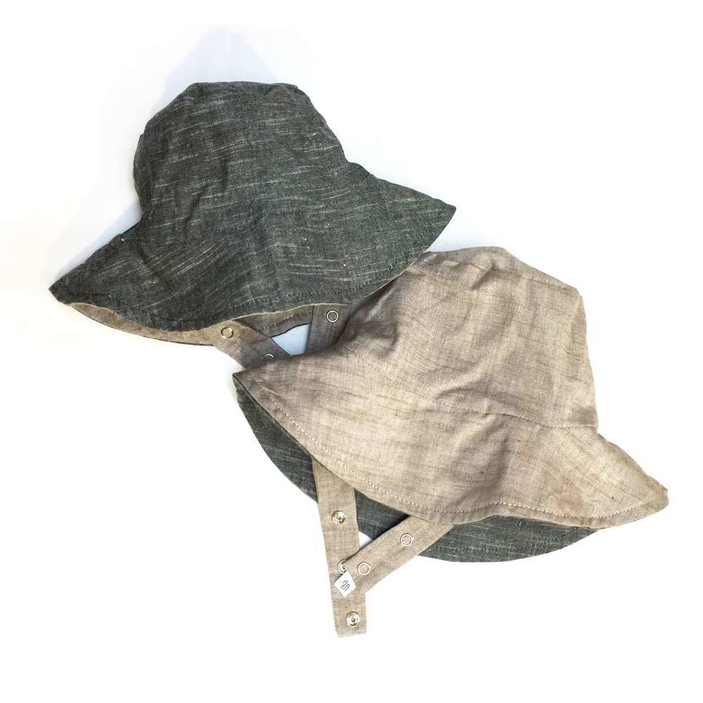 Two bucket hats, one dark gray and one beige, on a white background