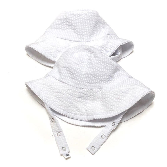 Two white textured bucket hats on a white background