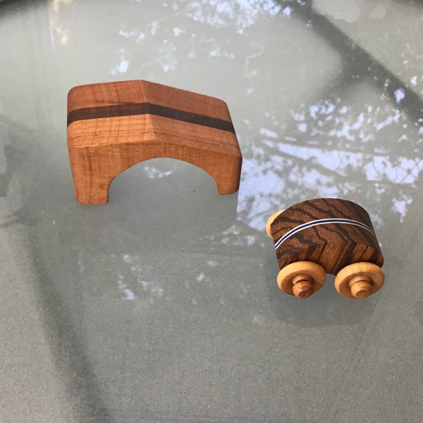 Wooden toy car with ramp on a glass table