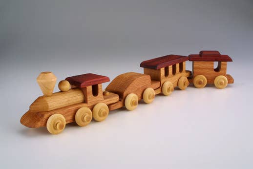 Wooden toy train on a gray background