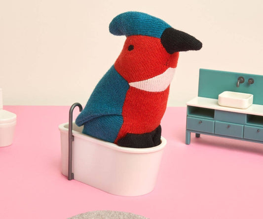 Organic kingfisher plush toy sitting in a tiny bathtub