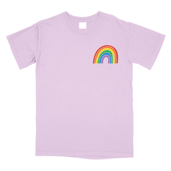 a pink t-shirt with a rainbow on the chest laid flat on a white background