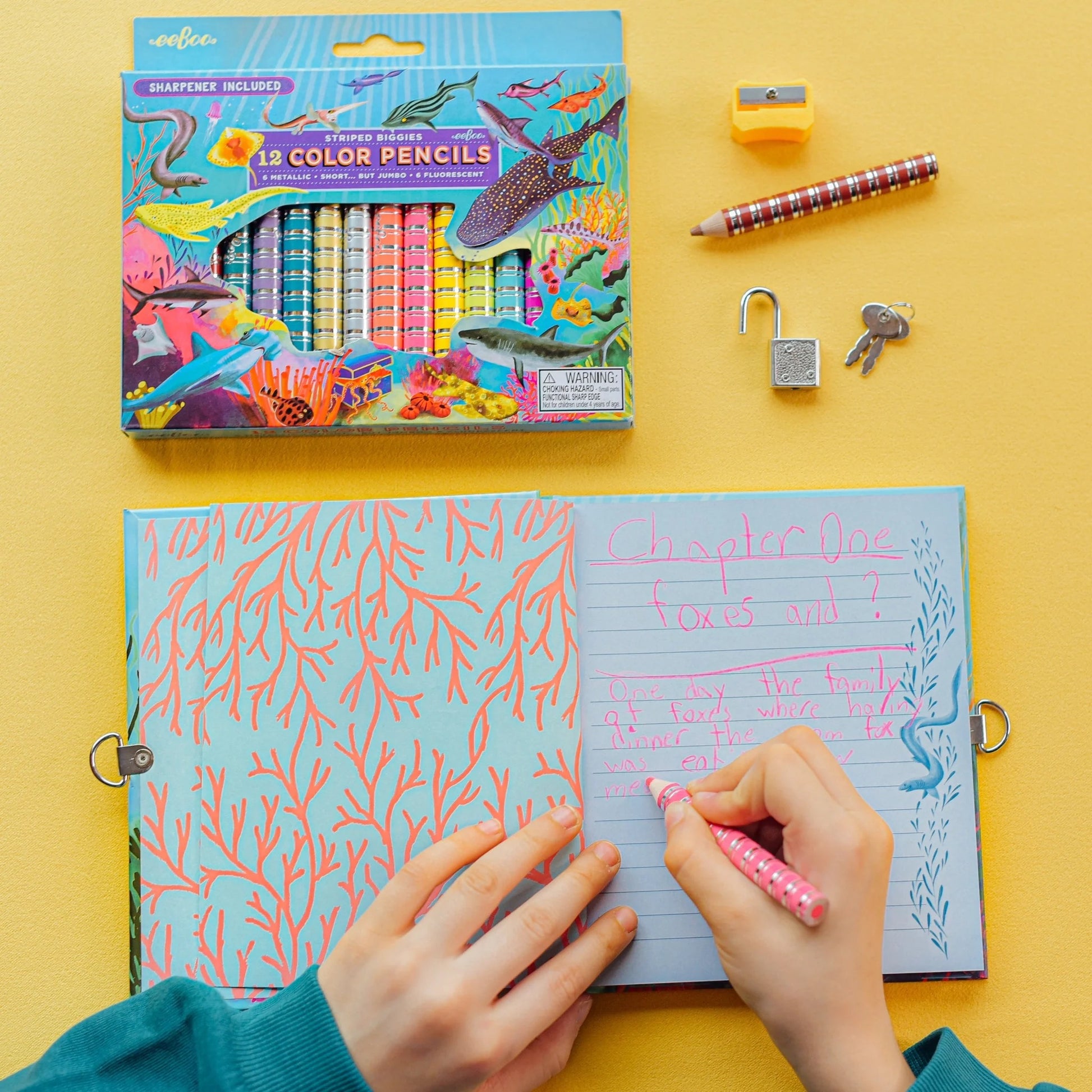 child writing in a journal with Sharks Biggie Pencils