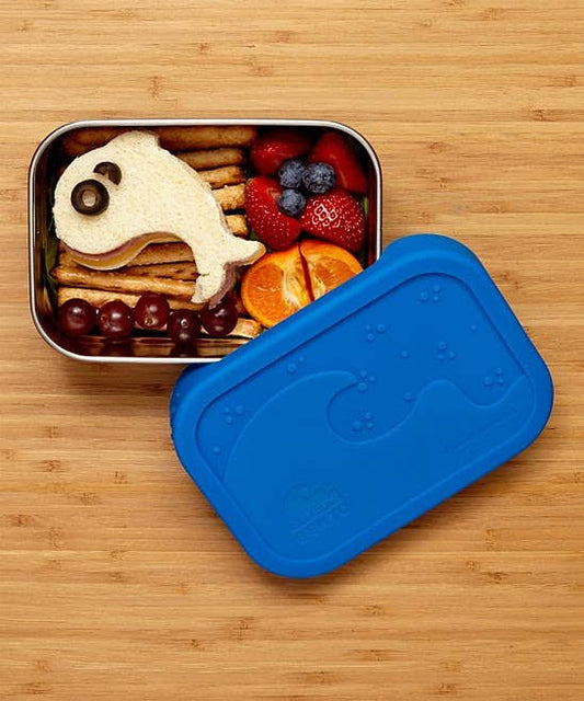 Bento box with a fish-shaped sandwich and fruits on a wooden table