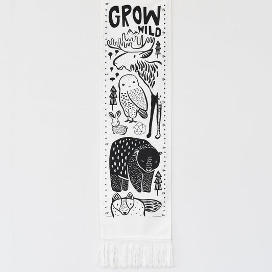 Growth chart with black animal illustrations and 'Grow Wild' text on a white background