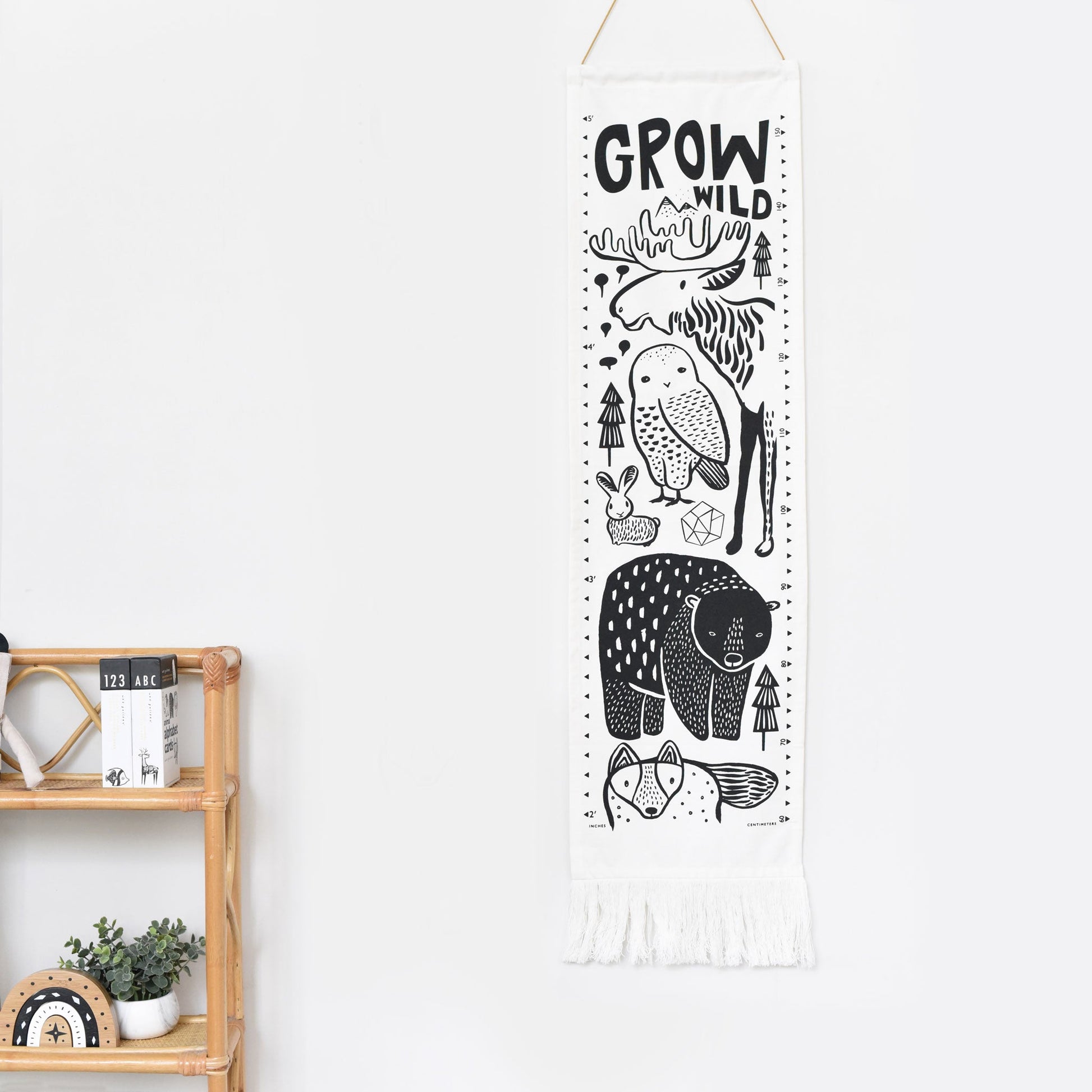 Decorative banner with animal illustrations and 'Grow Wild' text on a white wall.
