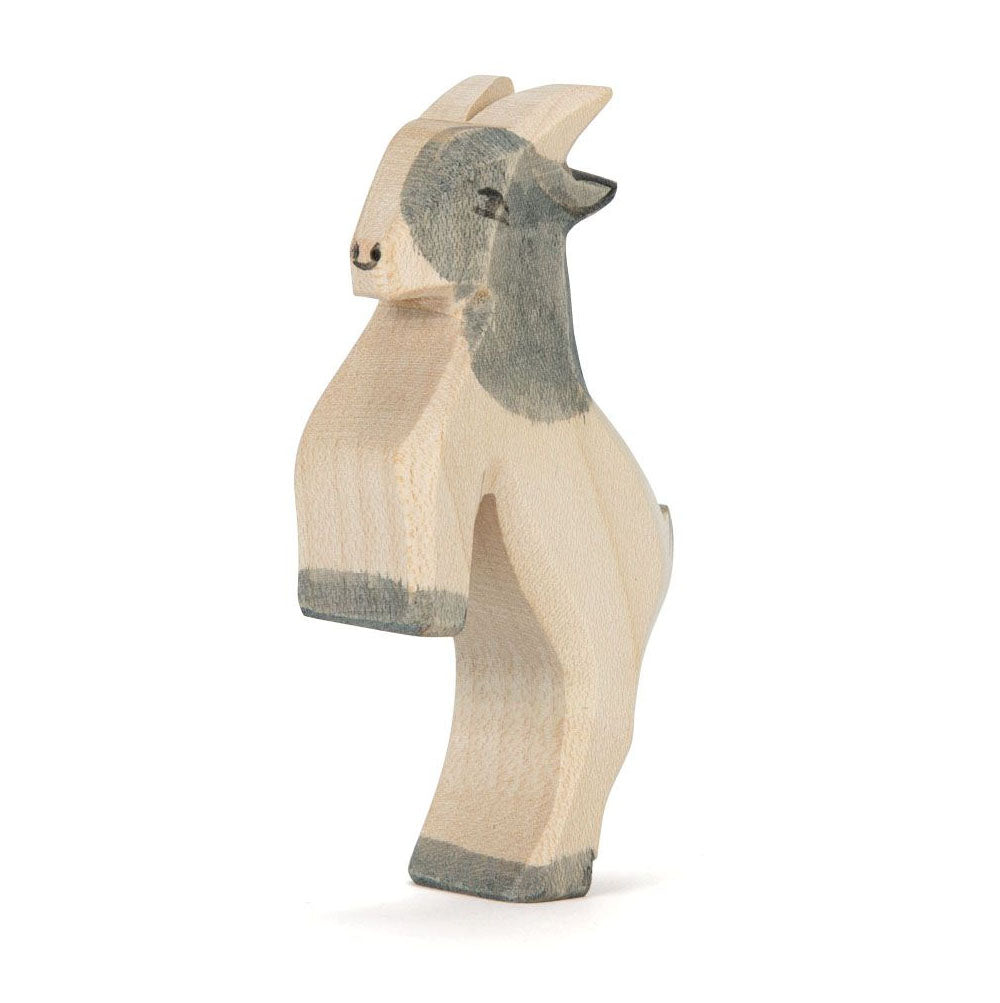 hand carved wooden goat jumping by ostheimer on a white background