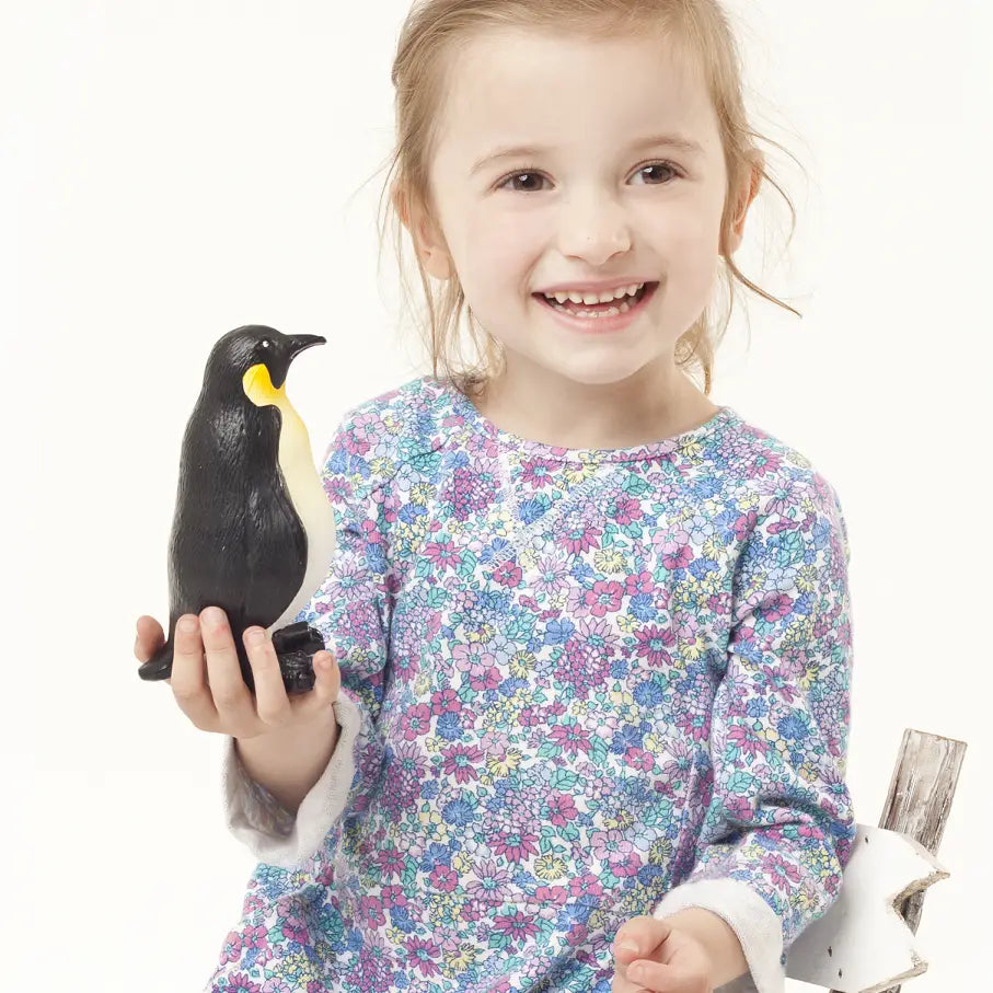 Kid holding a natural rubber penguin