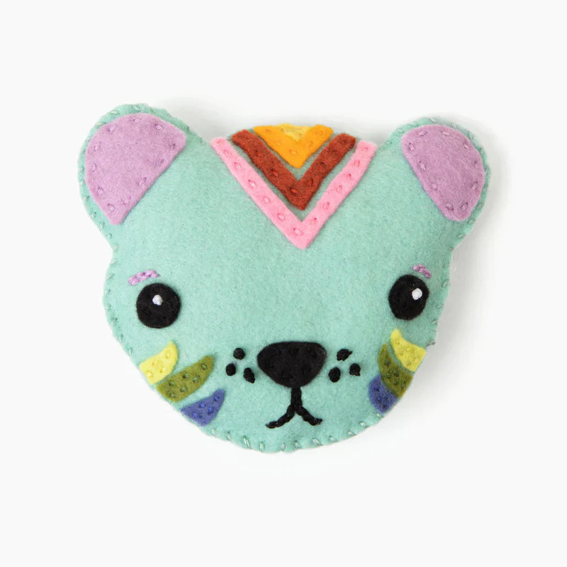 Heart-shaped plush toy with a cat face design on a white background