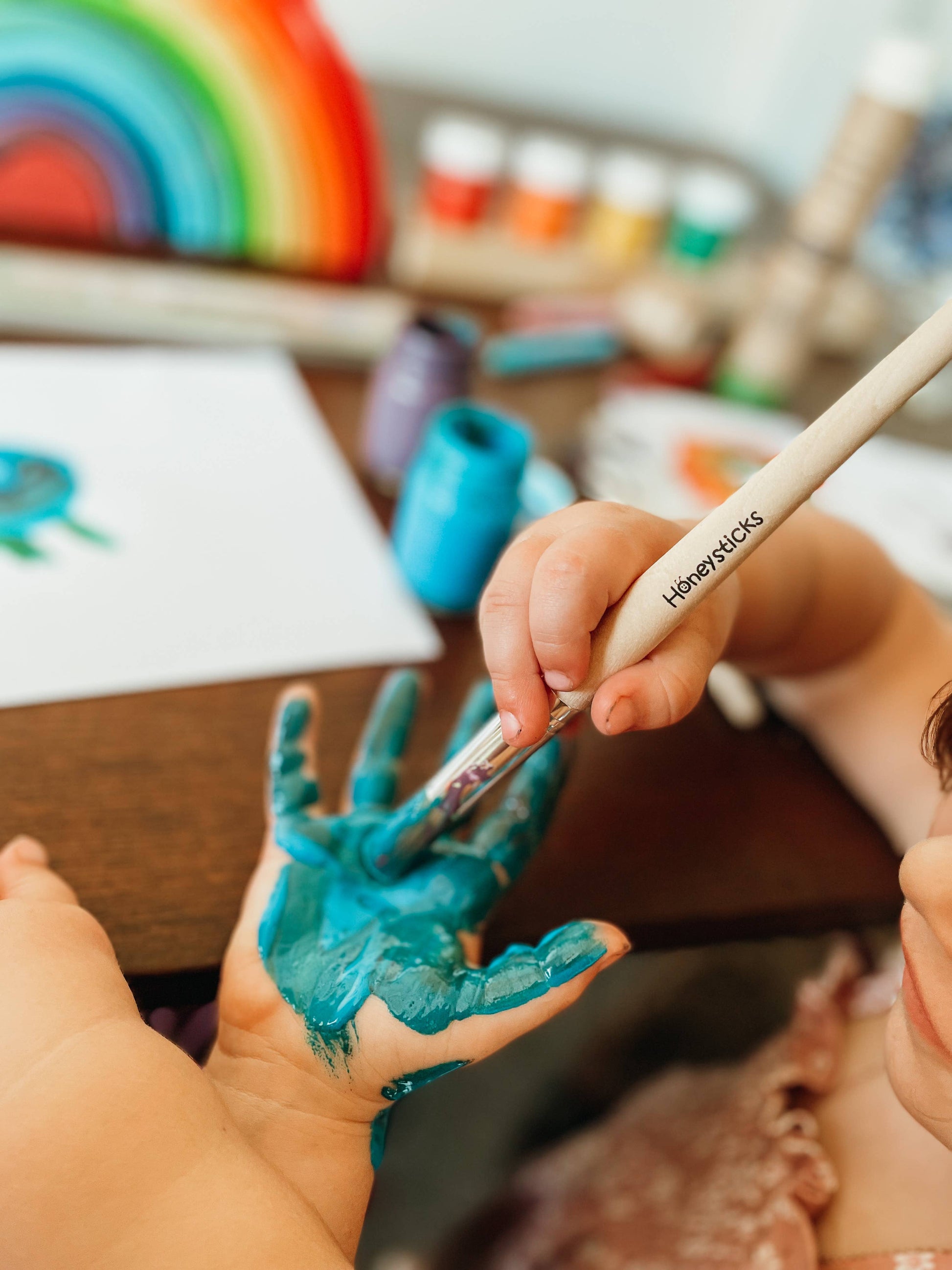 close up of a child's hand being painted on