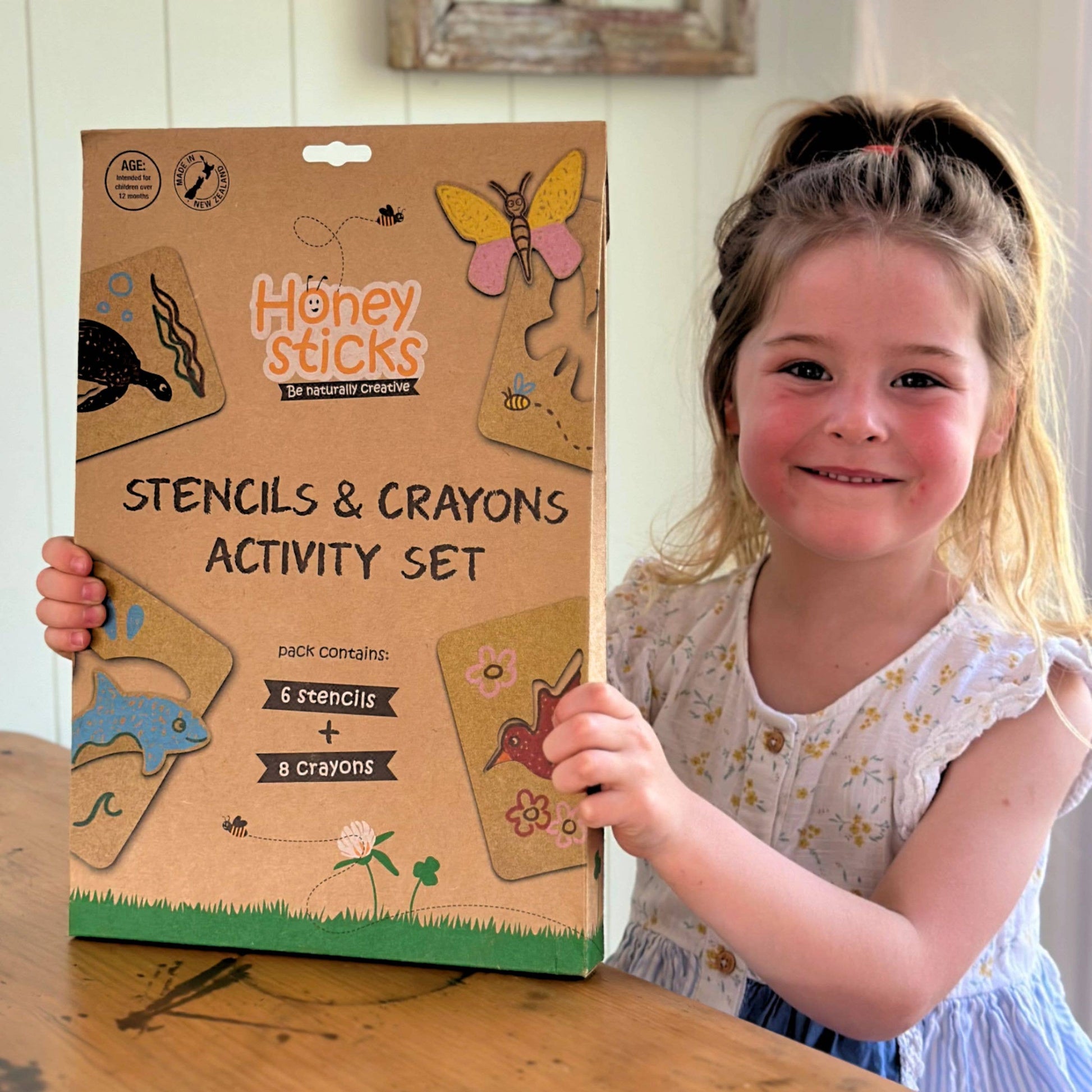 Child holding the box for stencils and crayons set