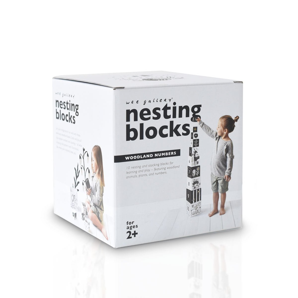 Box of Wee Gallery nesting blocks with a child playing with blocks on a white background